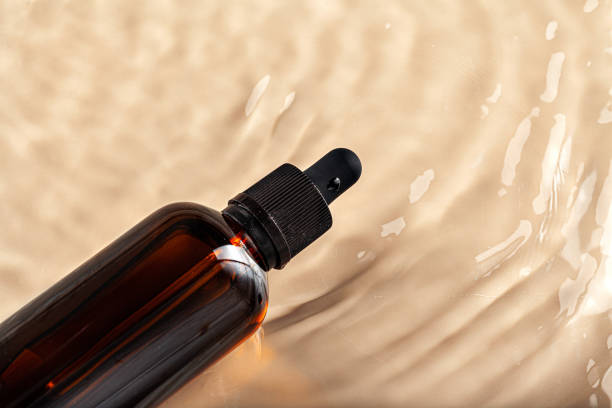 istock Cosmetic bottle with pipette in wavy water 1222964727