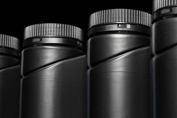 istock Engine oil bottle on black background, close up. 1222964824