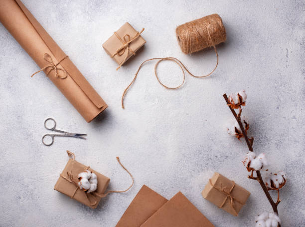 istock Process of packing gifts boxes in craft paper. 1222965582
