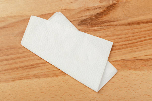 istock white paper napkin or tissue on the wooden table background. 1222965703