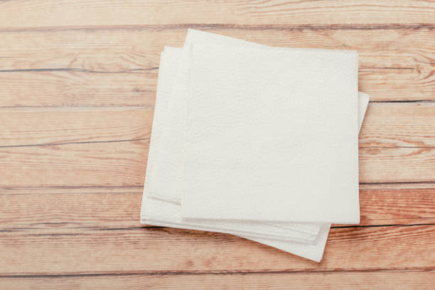 istock white paper napkin or tissue on the wooden table background. 1222965801