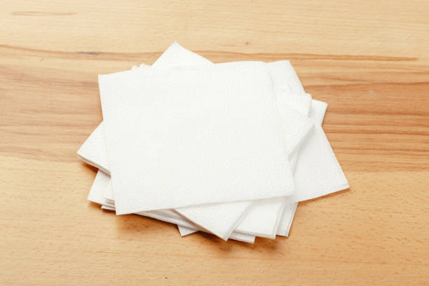 istock white paper napkin or tissue on the wooden table background. 1222965830