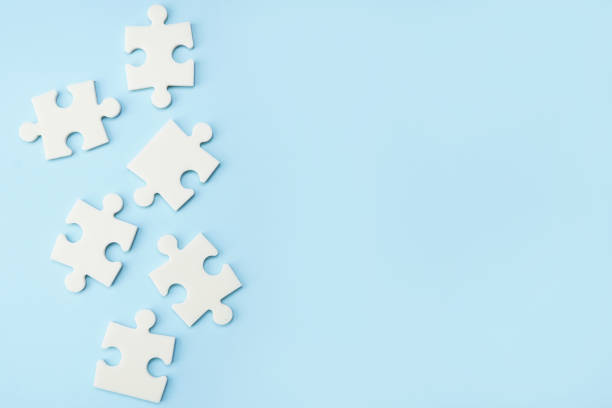 istock white puzzle pieces on blue background with copy space 1222966164