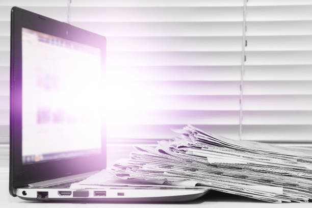 istock Newspapers and Laptop 1222970088
