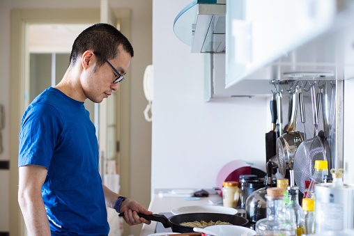 A mid adult man preparing vegan gyoza at home.