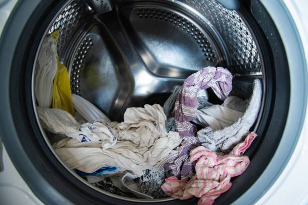 istock Freshly washed laundry sitting in the washing machine 1222971249