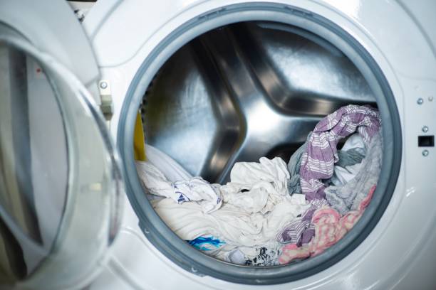 istock Freshly washed laundry sitting in the washing machine 1222971390