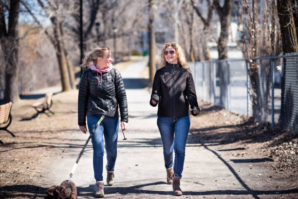 istock Two blond women walking a dog 1222971391