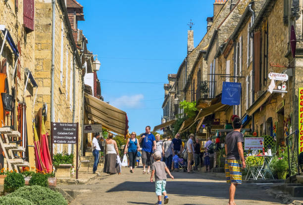 Domme, Dordogne / France - August 1st, 2015: People walking by the old city center