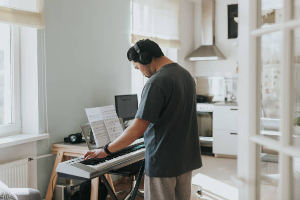 istock Japanese man plays synthesizer at home during social distancing and lockdown 1222973602