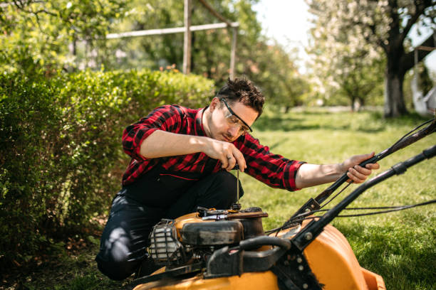 man checking a lawn mower in his back yard - lawn mower red plant lawn imagens e fotografias de stock
