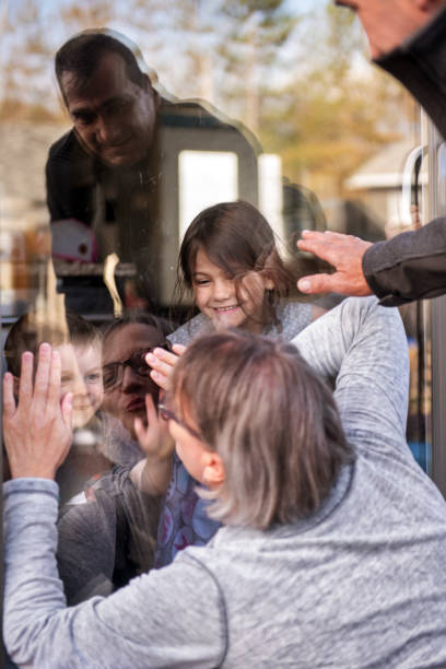 istock Grandparents visiting grandkids during quarantine through window 1222974858