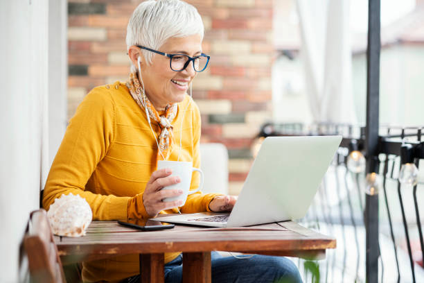 istock Mature woman on balcony working at home office 1222975076