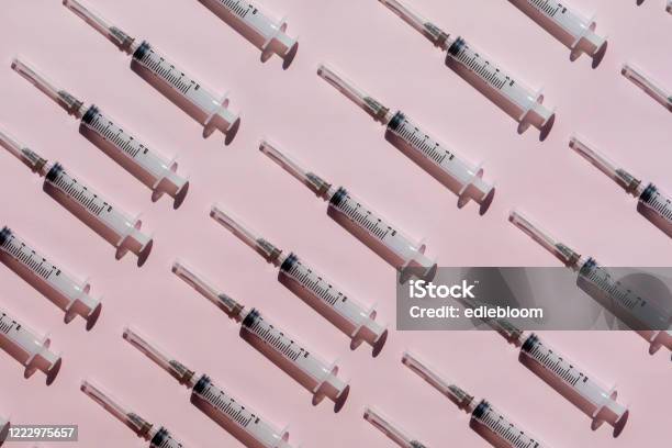 Syringe Background Stock Photo - Download Image Now - Vaccination, Syringe, Pink Color