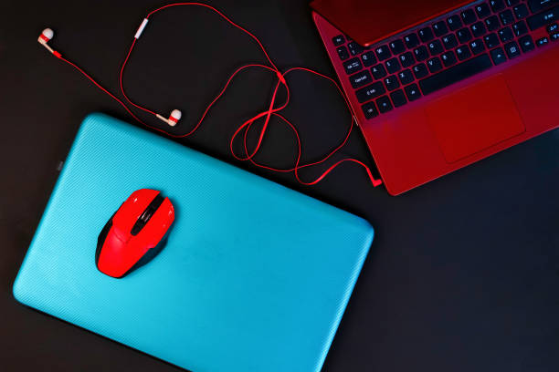 istock Top view of two colored laptops, turquoise and red 1222976502