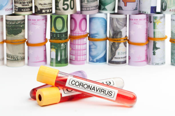 istock Coronavirus , COVID 19 test tubes and Rolled currency 1222981340