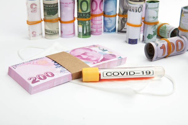 istock Coronavirus , COVID 19 test tubes and Rolled currency 1222981395