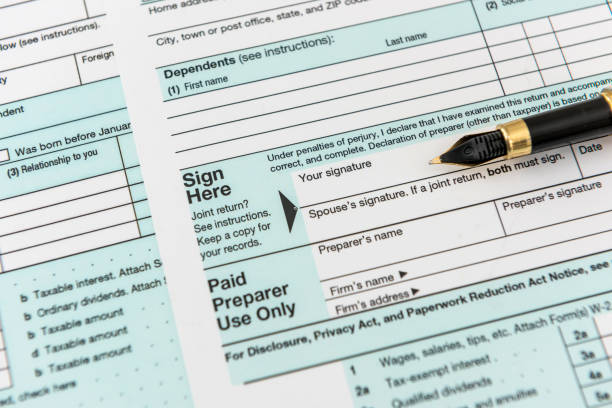 istock 1040 tax form with pen, finance document 1222982516
