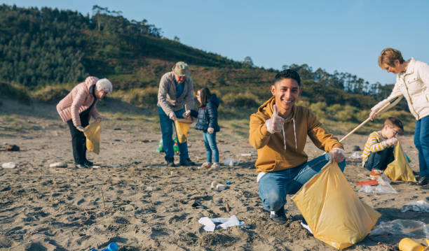 istock Young man cleaning the beach 1222983840