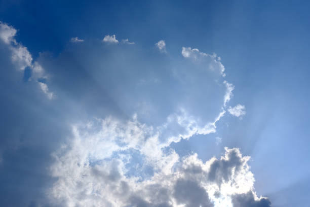 istock Sunbeam, sunlight through the haze, cloud on the blue sky . Cloud with sun ray. 1222984268