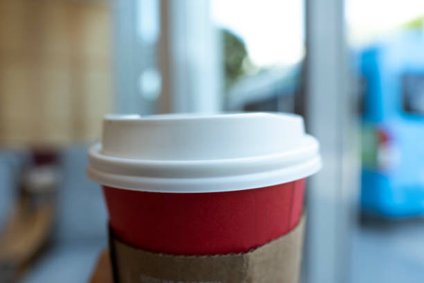 istock Blurred Red paper coffee cup with White plastic lid in bokeh blurred background, Close up & Macro shot, Selective focus, About drink concept 1222984469