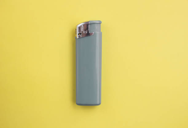 istock gray lighter on bright yellow and background close-up. Top view. Mock up. Flat lay composition 1222984530