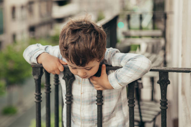 istock Boy looking from balcony during Lockdown for COVID-19 1222988831