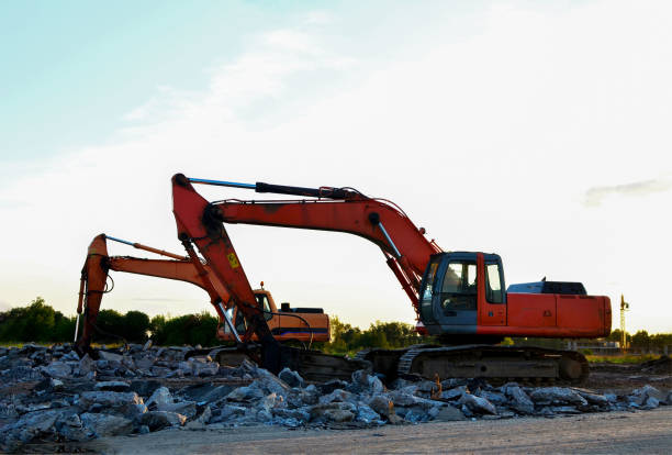 istock Crawler excavator with hydraulic breaker hammer on sunset. 1222998031