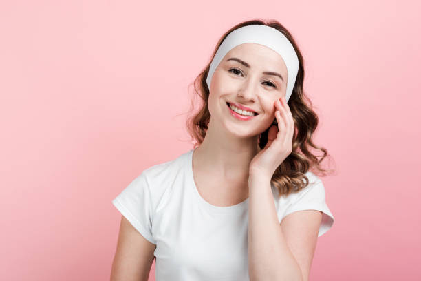 istock Smiling girl posing with headband. Isolated on pink background. 1222998325