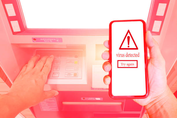istock Closeup hands to press the ATM key in the red cabinet. Finger pressing a pin code on a number pad. Security code on an pink automated teller machine (ATM) on light background. 1222999002