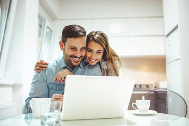 istock Attractive woman spending time on the internet with her husband 1222999775