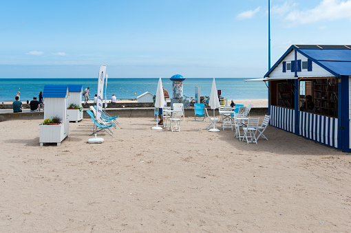 A special library in a kiosk next to the beach in Lion sur Mère in Normandy. People can lend a book and read it sitting on the terrace. Lion sur Mère is one of the villages on the Sword invasion beach of WW2.