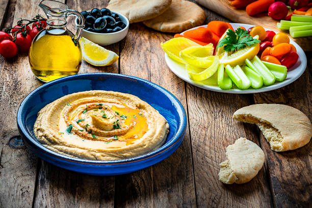 istock Vegan food: hummus in a plate with pita bread and vegetables. 1223001439