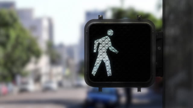 Medium shot showing close up of pedestrian walk signal from walk figure to don't walk