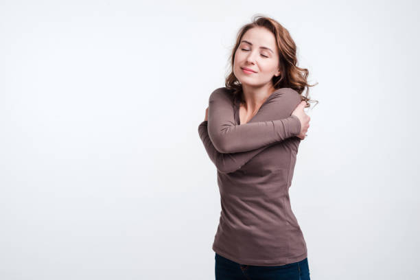 istock Pretty woman hugging herself. Calmness and  care concept image 1223003410