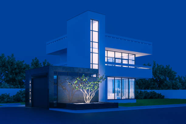 istock Modern house with white plaster with a balcony and a high staircase, in cold night light with warm light from the Windows against the background of trees and a white fence 3D stock illustration. 1223003744