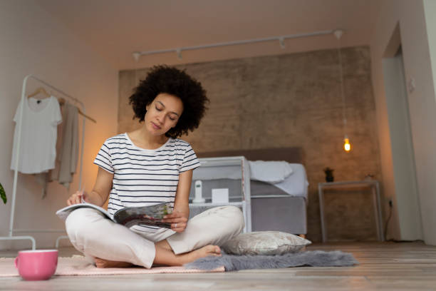 istock Woman reading a magazine and drinking coffee 1223004093