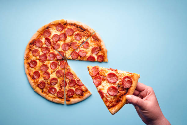 istock Taking a slice of pepperoni pizza top view. 1223006590