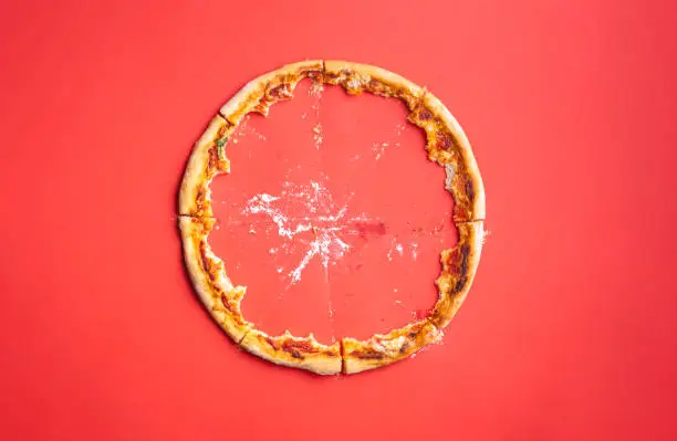 Photo of Pizza crust leftovers and crumbs top view.