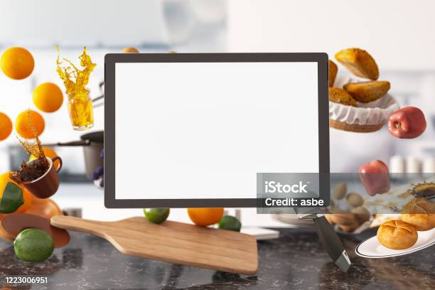 Zero Gravity In Kitchen Levitation Concept With Foods And Empty Screen Tablet Stock Photo - Download Image Now