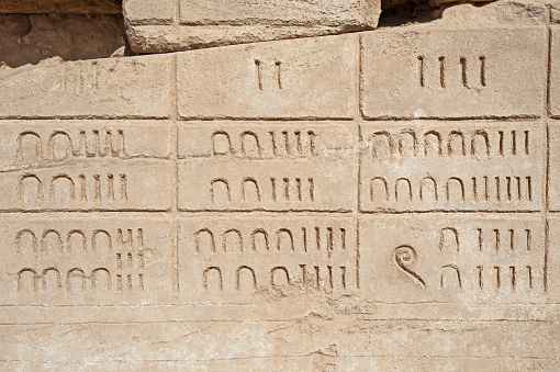 Hieroglypic numerical carvings on wall at the ancient egyptian temple of Karnak in Luxor