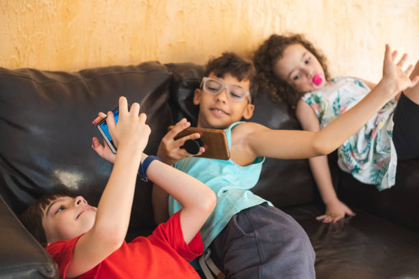 istock Happy children using smart phones 1223010888