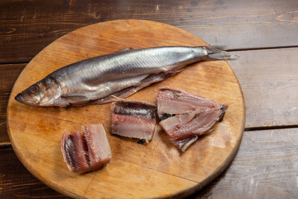 istock ready-to-eat salted herring from plastic packaging on brown desk . 1223012470