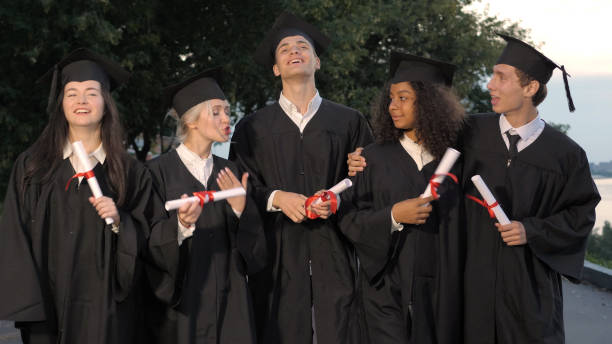 istock Group of graduating students walking and talking 1223013332