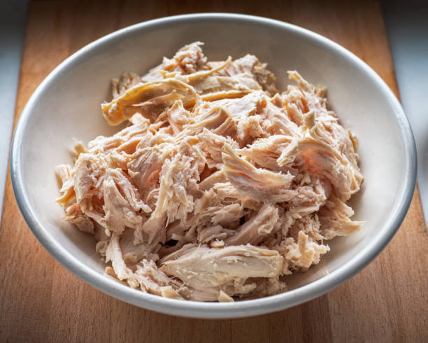 istock Sliced boiled chicken fillet for salads and pie toppings in a deep light plate 1223014566