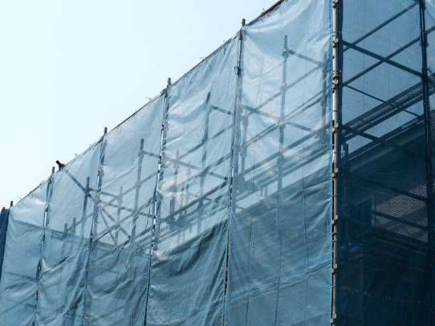 istock Blue sheet covering the building under construction 1223015717