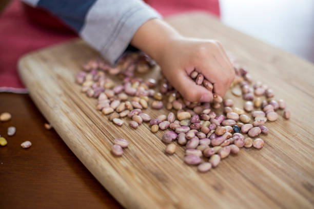 Mother and son, cleaning beans at home