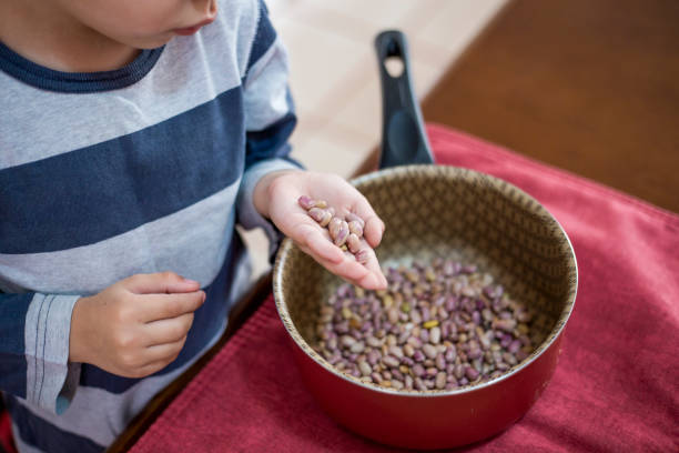 Mother and son, cleaning beans at home