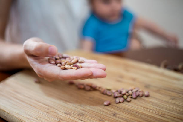 Mother and son, cleaning beans at home