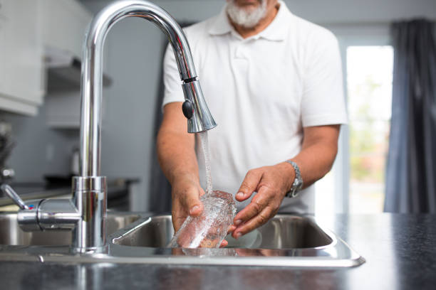 istock Senior man washing dishes in his modern, bright kitchen 1223018072